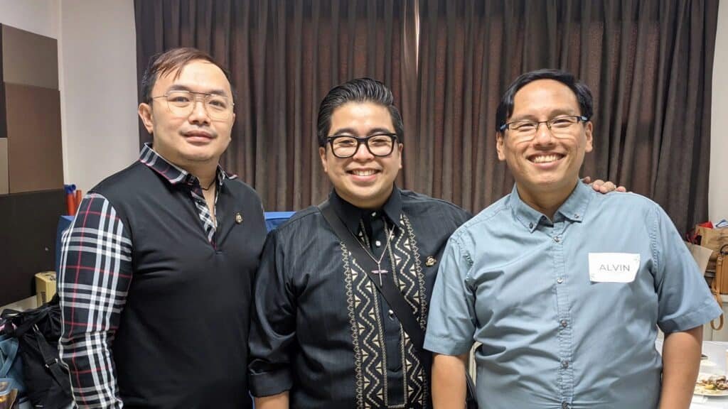 Three men posing for a picture in a room.