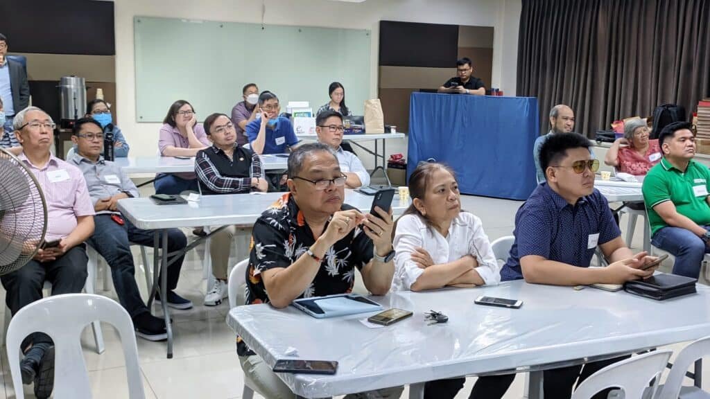 A group of people sitting at tables in a room.