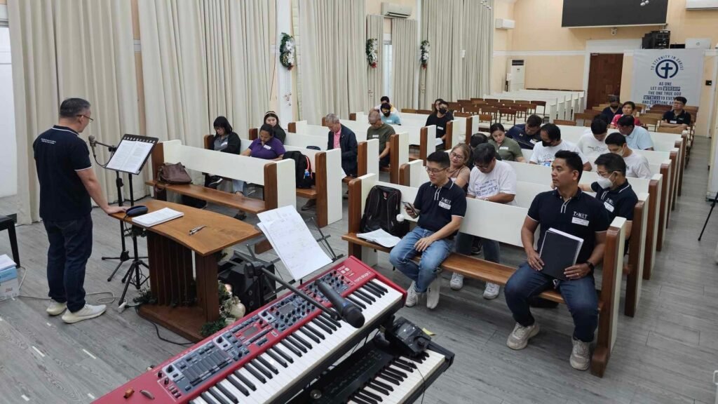 A group of people in a church listening to music.