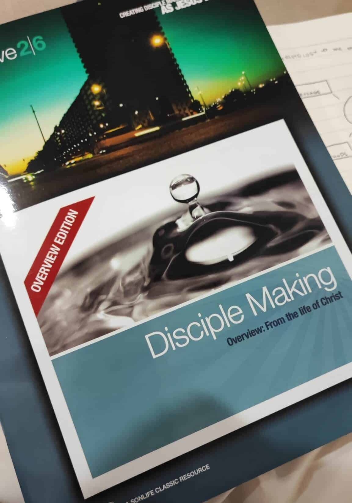 A book titled disciple making is sitting on a table.